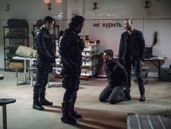 Arrow -- "Promises Kept" -- Image AR606a_0006b.jpg -- Pictured (L-R): Liam Hall as Kane Wolfman, Manu Bennett as Slade Wilson/Deathstroke, Stephen Amell as Oliver Queen, and Kris Holden-Reid as Nylander -- Photo: Jack Rowand/The CW -- ÃÂ© 2017 The CW Network, LLC. All Rights Reserved.