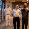 Arrow -- "The Demon" -- Image Number: AR705a_0024b -- Pictured (L-R): Josh Blacker as Magee (center) and Stephen Amell as Oliver Queen/Green Arrow (far right) -- Photo: Jack Rowand/The CW -- ÃÂ© 2018 The CW Network, LLC. All Rights Reserved.