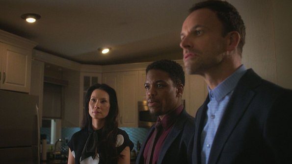 "The Games Underfoot" -- When an archeologist is murdered, Holmes and Watson believe the man may have been killed for what he discovered during his last excavation in a local landfill. Also, Sherlock\'s relationship with Alfredo, his friend and former sobriety sponsor, hits a rough patch, on ELEMENTARY, Thursday, Dec. 10 (10:00-11:00 PM, ET/PT) on the CBS Television Network.  Pictured (L-R)  Lucy Liu  as Joan Watson , Jon Michael Hill  as Detective Marcus Bell and    Jonny Lee Miller as Sherlock Holmes Best Possible Screen Grab/ CBS ÃÂ©2015 CBS Broadcasting Inc. All Rights Reserved.