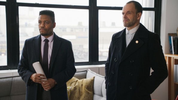 "Moving Targets" -- When a reality show contestant is murdered, Holmes and Watson zero in on another competitor as a suspect, a former war criminal who may be the most skilled killer they\'ve ever pursued. Also, for the first time since he attacked Sherlock, Shinwell reaches out to Joan to ask for a favor, on ELEMENTARY, Sunday, May 7 (10:00-11:00 PM, ET/PT) on the CBS Television Network. Series star Lucy Liu directed the episode.  Pictured Jon Michael Hill as Detective Marcus Bell and Jonny Lee Miller as Sherlock Holmes Photo: Best Possible Screen Grab/CBS ÃÂ©2017 CBS Broadcasting, Inc. All Rights Reserved