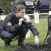 BONES:  Brennan (Emily Deschanel) investigates evidence from a murder scene in Arlington Cemetery in the BONES episode "The Soldier on the Grave" airing Wednesday, May 10 (8:00-9:00 PM ET/PT) on FOX.  
