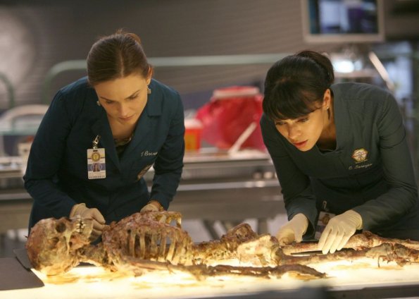 BONES: Brennan (Emily Deschanel, L) and Cam (Tamara Taylor, R) examine the remains of a young boy who could help them convict the Gravedigger in the BONES episode "The Boy with the Answer" airing Thursday, May 13 (8:00-9:00 PM ET/PT) on Fox. ©2010 Fox Broadcasting Co. Cr: Mathieu Young/FOX BONES: Brennan (Emily Deschanel, L) and Cam (Tamara Taylor, R) examine the remains of a young boy who could help them convict the Gravedigger in the BONES episode "The Boy with the Answer" airing Thursday, May 13 (8:00-9:00 PM ET/PT) on Fox. ©2010 Fox Broadcasting Co. Cr: Mathieu Young/FOX